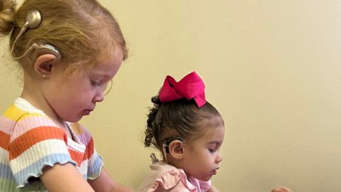 Two girls, students at our Sound Start auditory/verbal therapy program for children with cochlear implants or hearing aids.