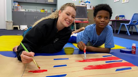 Heather Woodbury OTR with boy in SSHC Occupational Therapy gym.jpg